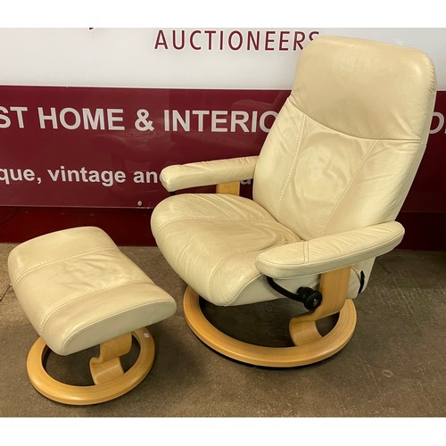 62 - A Norwegian Ekornes beech and cream leather Stressless revolving lounge chair and footstool