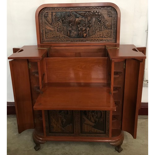 129 - A Chinese carved hardwood cocktail cabinet