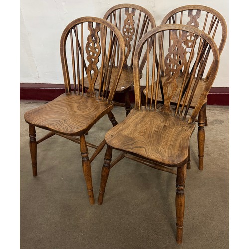 138 - A set of four Victorian elm and beech wheelback kitchen chairs