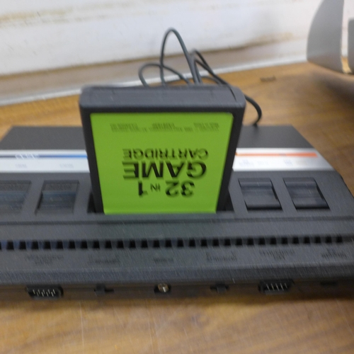 5067 - An Atari 2600 video computer system in original box with a 32in1 game cartridge, sold with power sup... 