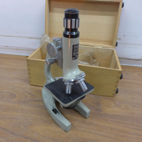 5072 - A Prinz Optics model 300L 80X-1200X zoom student microscope in wooden storage case