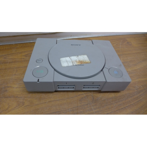 5075 - Two Sony PlayStation One games consoles with one official Sony PlayStation controller, one after mar... 