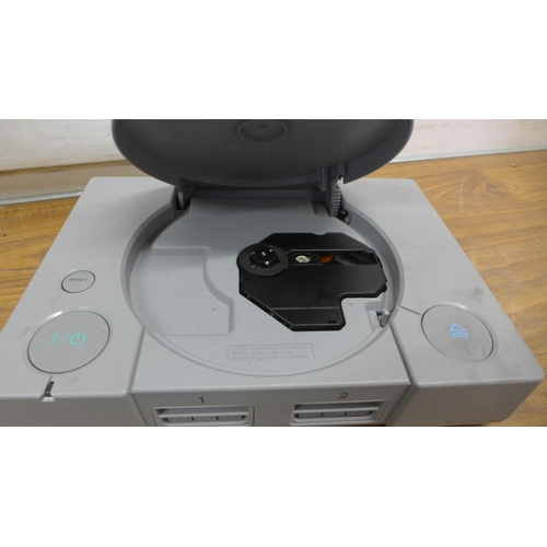 5075 - Two Sony PlayStation One games consoles with one official Sony PlayStation controller, one after mar... 