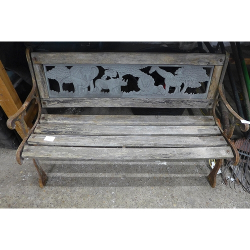 5193 - A miniature garden bench with animal decoration