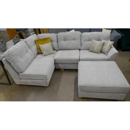 3181 - A grey fabric upholstered corner sofa and footstool