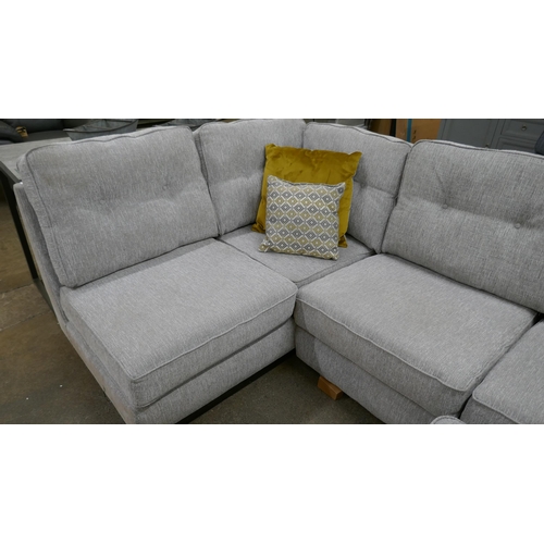 3181 - A grey fabric upholstered corner sofa and footstool