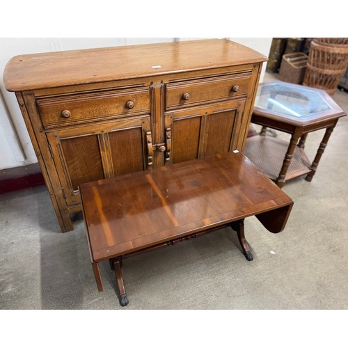 222 - An octagonal mahogany and glass topped occasional table, a drop-leaf coffee table and an elm sideboa... 