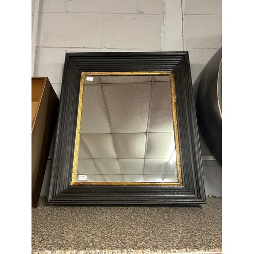 3198 - A black and gold framed mirror