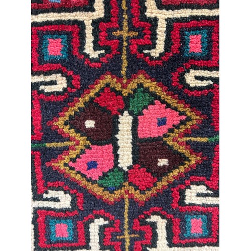 3195 - A full pile Persian runner, red ground medallion design