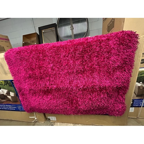 3196 - A full pile pink ground shaggy rug