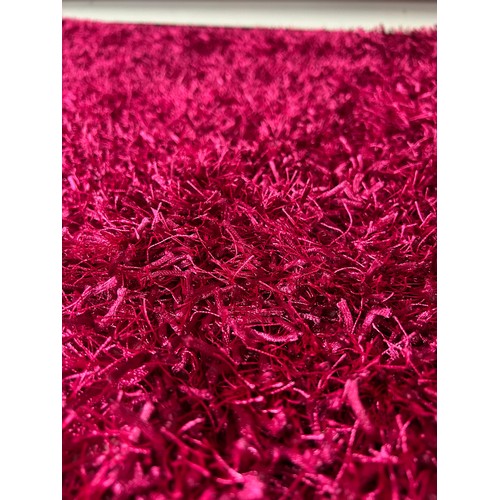 3196 - A full pile pink ground shaggy rug