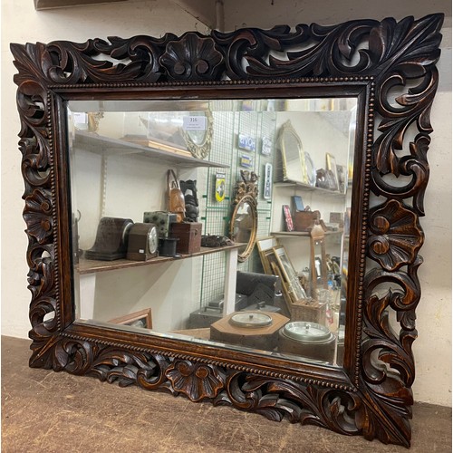 316 - A Victorian carved oak framed mirror