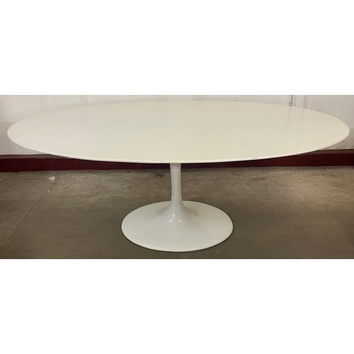 69D - An Eero Saarinen style white laminate oval tulip dining table and six chairs