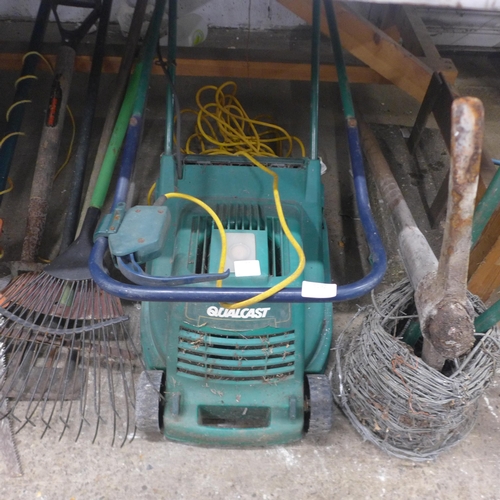 5192 - A quantity of gardeners tools including an electric Qualcast lawn mower, a tree pruner, rakes, pick ... 