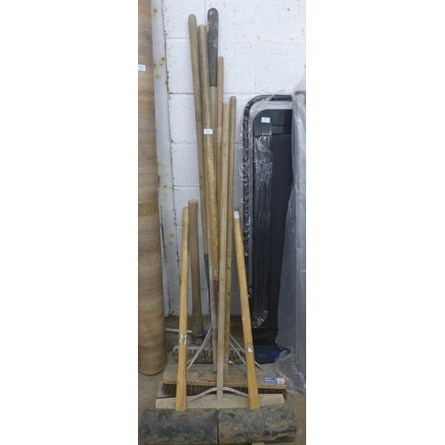 5210 - A quantity of garden tools including rakes, rubber mallets, a brush and a Mattock axe