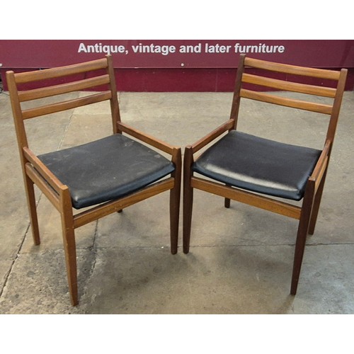 6 - A pair of teak and black vinyl side chairs