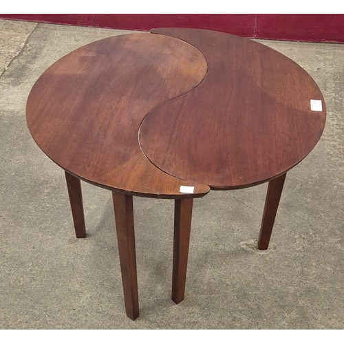 28 - A teak two piece circular puzzle coffee table