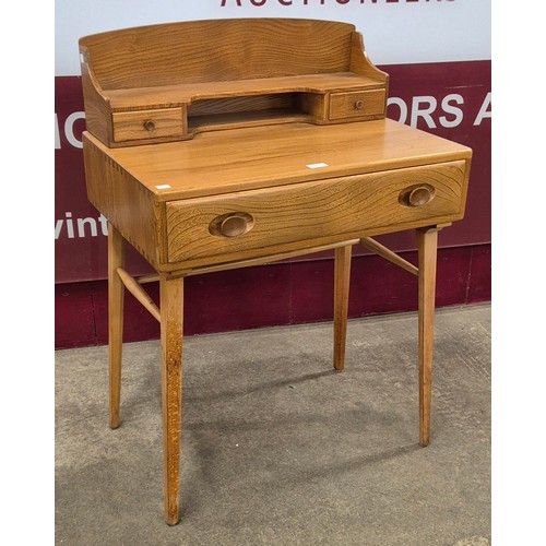 38 - An Ercol Blonde elm and beech 439 model Windsor desk