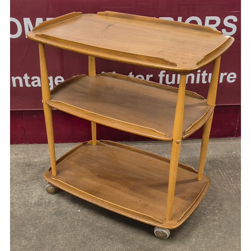 42 - An Ercol Blonde elm and beech Windsor trolley