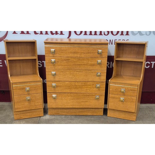 54 - A simulated teak chest of drawers and a pair of bedside chests