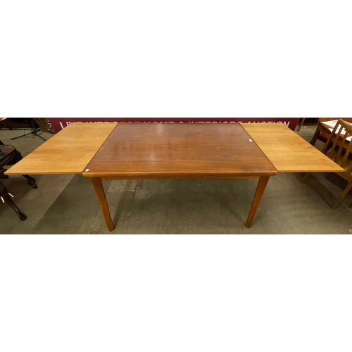 61 - A Danish teak rectangular extending dining table and a set of four G-Plan Fresco teak dining chairs