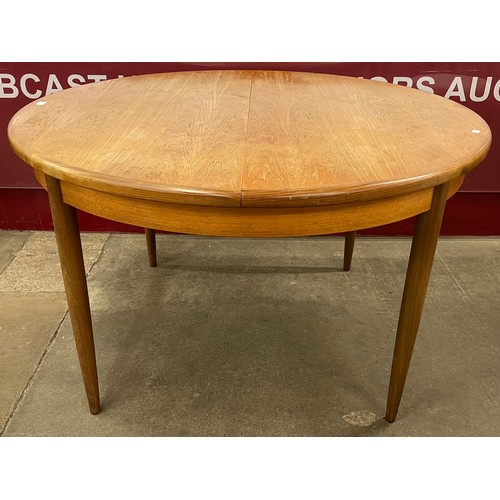 62 - A G-Plan Fresco teak circular extending dining table and six chairs