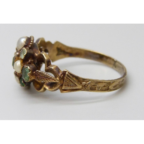 7001 - A Victorian yellow metal ring set with emeralds and seed pearls, 2.5g, O