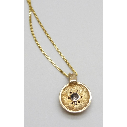 7002 - A 9ct gold and diamond set pendant on a 9ct gold chain, 3.9g total, 1.7cm pendant