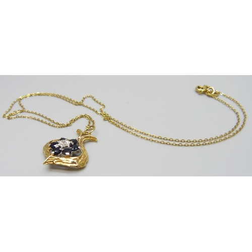 7003 - A 9ct gold, sapphire and diamond pendant on a 9ct gold chain, 2.6g total, 2cm pendant