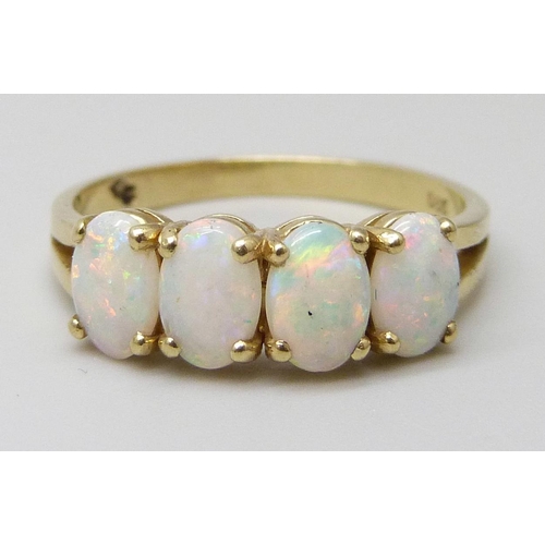 7020 - A 14ct gold ring set with four opals, 2.1g, M/N