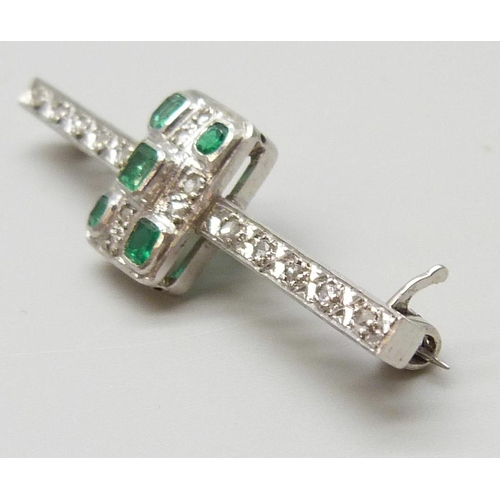 7039 - An Art Deco platinum set emerald and diamond bar brooch, 6.2g, 4.9cm, with box