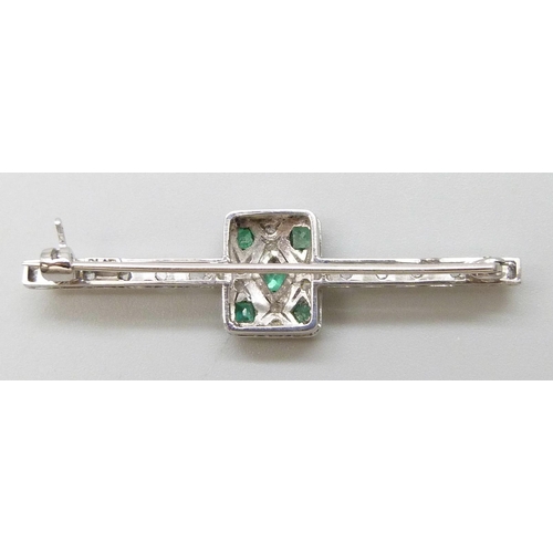 7039 - An Art Deco platinum set emerald and diamond bar brooch, 6.2g, 4.9cm, with box