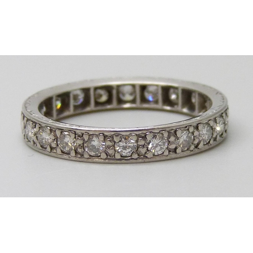 7043 - A white metal diamond set eternity ring, tests as platinum, 4.1g, N/O