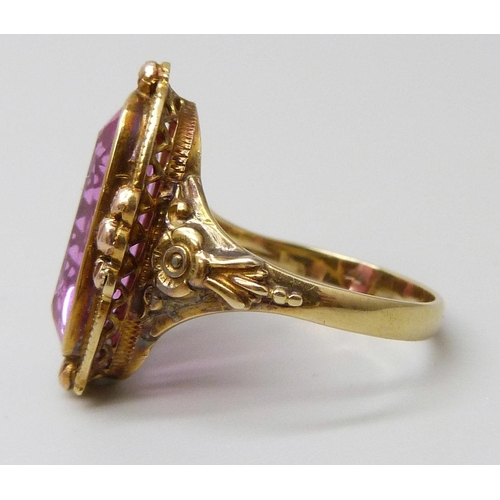 7047 - A 14ct gold ring set with a large pink topaz, 1.6cm x 0.7cm, with French marks, 4.9g, O