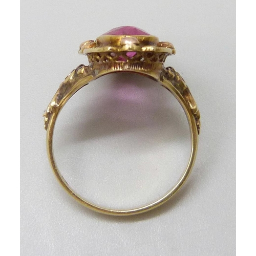 7047 - A 14ct gold ring set with a large pink topaz, 1.6cm x 0.7cm, with French marks, 4.9g, O