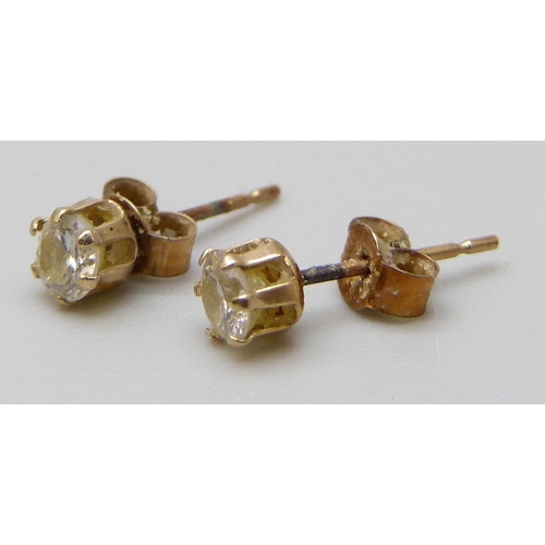 7054 - A pair of yellow metal diamond set stud earrings, 0.2g