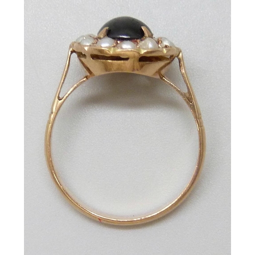 7058 - A 14k gold, cabochon stone and seed pearl ring, lacking one pearl, 2.8g, R