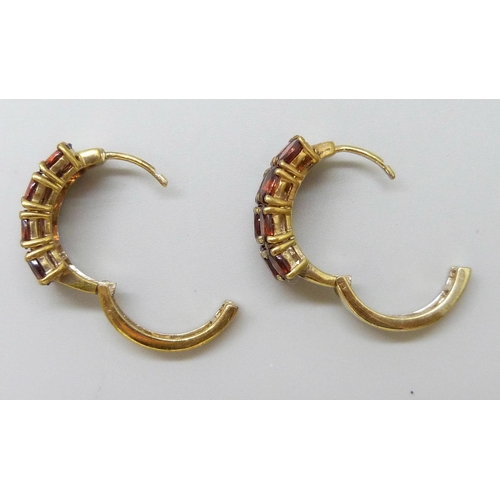 7060 - A pair of silver gilt garnet set cuff earrings, 1cm wide