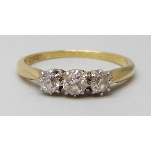 7063 - An 18ct gold and platinum set three stone diamond ring, 2.2g, M