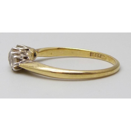 7063 - An 18ct gold and platinum set three stone diamond ring, 2.2g, M