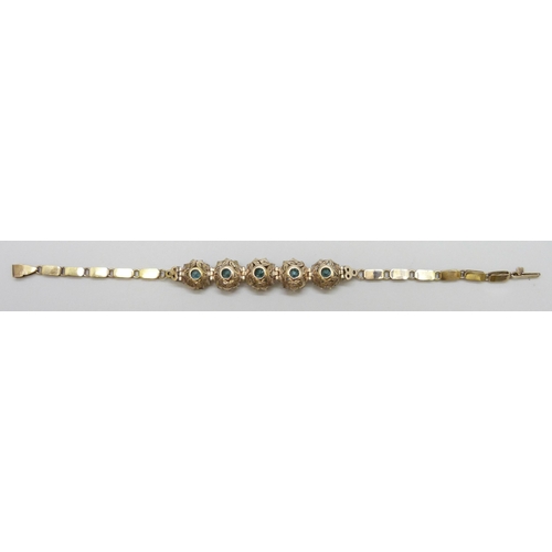 7064 - A yellow metal bracelet set with central topaz and white spinel clusters, 9.5g, 18.3cm