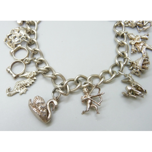 7081 - A silver charm bracelet with silver and white metal charms, 37g