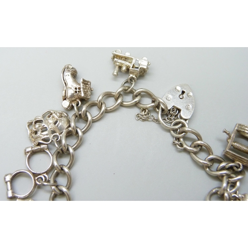 7081 - A silver charm bracelet with silver and white metal charms, 37g