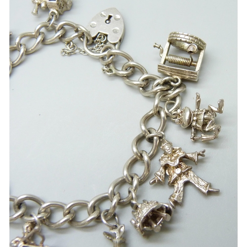 7081 - A silver charm bracelet with silver and white metal charms, 37g