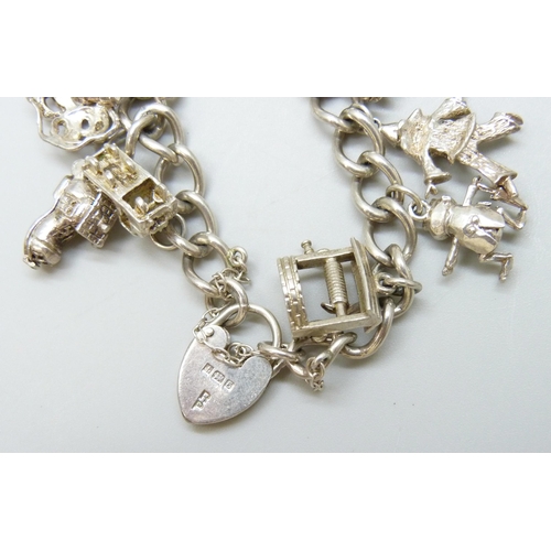 7081 - A silver charm bracelet with silver and white metal charms, 37g