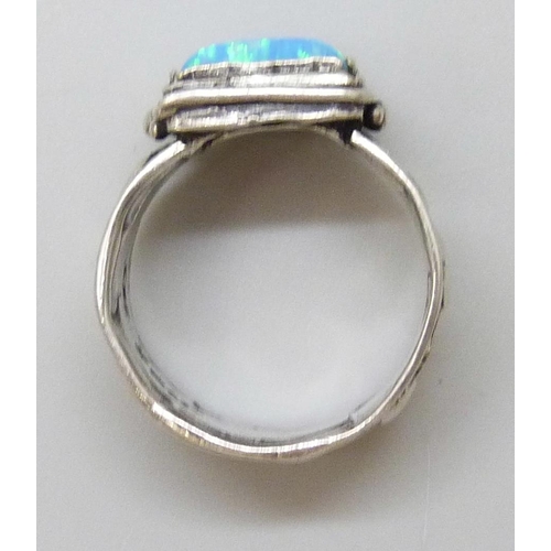 7083 - A silver synthetic opal set ring, signed, 7.4g, P