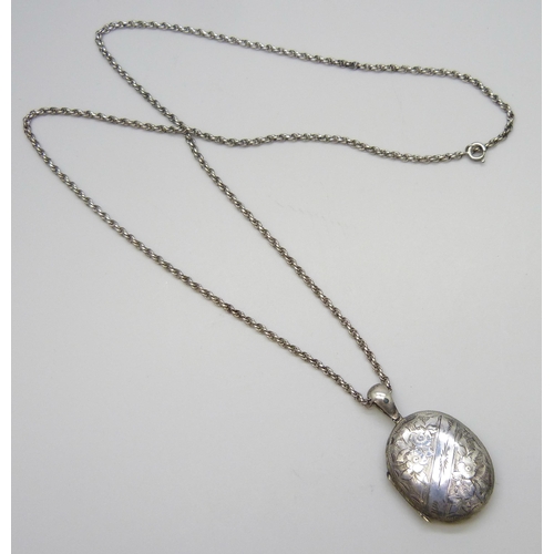 7084 - A Victorian white metal locket, 14g, 5cm, on a long chain