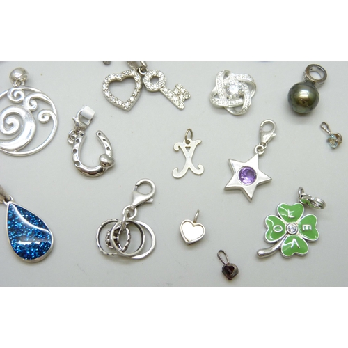 7086 - A collection of silver charms and pendants including TGGC, 43g, a white metal teddy bear charm and t... 