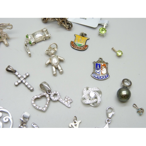 7086 - A collection of silver charms and pendants including TGGC, 43g, a white metal teddy bear charm and t... 