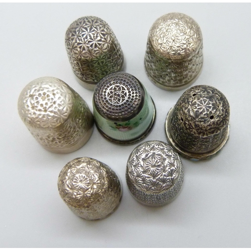 7127 - Four silver thimbles including a guilloche enamel example and Charles Horner, together with three ot... 